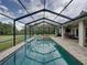 Inviting screened-in pool with chairs, lounge seating, and an open backyard at 3985 Mammoth Grove Rd, Lake Wales, FL 33898