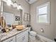 Stylish powder room with stone sink, modern fixtures, and a decorative mirror at 3985 Mammoth Grove Rd, Lake Wales, FL 33898