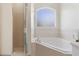 Relaxing bathroom featuring a large bathtub and a window for natural light at 4338 Dinner Lake Blvd, Lake Wales, FL 33859