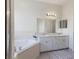 Bright bathroom featuring double sinks and a separate bathtub at 4338 Dinner Lake Blvd, Lake Wales, FL 33859