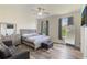 Bedroom with hardwood floors, TV, dresser, and lots of natural light at 4338 Dinner Lake Blvd, Lake Wales, FL 33859