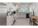 Bright kitchen featuring white cabinetry, stainless steel appliances, and tile flooring at 4338 Dinner Lake Blvd, Lake Wales, FL 33859