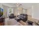 Bright living room offering wood floors and comfortable black leather seating at 4338 Dinner Lake Blvd, Lake Wales, FL 33859