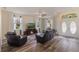 Comfortable living room featuring hardwood floors, a ceiling fan, and a entertainment center at 4338 Dinner Lake Blvd, Lake Wales, FL 33859