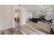 Open-concept living room featuring hardwood flooring and a decorative archway at 4338 Dinner Lake Blvd, Lake Wales, FL 33859
