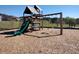 Community playground with wooden structure featuring slides, swings, and climbing areas at 4338 Dinner Lake Blvd, Lake Wales, FL 33859