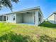 Backyard featuring a covered patio with a ceiling fan and green grass at 481 Kensington View Dr, Winter Haven, FL 33880