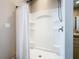 Clean shower stall featuring built-in shelving, modern fixtures, and a clear curtain at 481 Kensington View Dr, Winter Haven, FL 33880