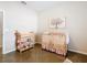 Bedroom featuring a wooden crib and changing table at 481 Kensington View Dr, Winter Haven, FL 33880