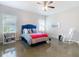Bright bedroom features a ceiling fan, windows, and a stylish blue headboard at 481 Kensington View Dr, Winter Haven, FL 33880