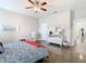 Spacious bedroom features a ceiling fan, dresser, and a comfortable rocking chair at 481 Kensington View Dr, Winter Haven, FL 33880
