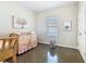 Cozy Bedroom with a wooden crib, a rocking bunny, and neutral decor at 481 Kensington View Dr, Winter Haven, FL 33880