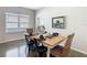 Elegant dining area with a wood table set for four, complemented by natural light from a nearby window at 481 Kensington View Dr, Winter Haven, FL 33880