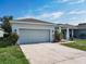Charming single Gathering home with a well-manicured front yard and a two car garage at 481 Kensington View Dr, Winter Haven, FL 33880
