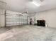 A spacious two car garage with overhead storage and additional space for storage and lawn equipment at 481 Kensington View Dr, Winter Haven, FL 33880