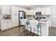 Charming kitchen with stainless steel appliances, an island with bar seating, and ample cabinet space at 481 Kensington View Dr, Winter Haven, FL 33880