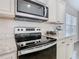 The kitchen showcases a stainless steel range and microwave, complemented by neutral countertops and cabinetry at 481 Kensington View Dr, Winter Haven, FL 33880
