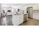 Open concept kitchen featuring a center island with stainless steel dishwasher, refrigerator and clear sight lines at 481 Kensington View Dr, Winter Haven, FL 33880