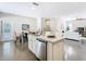 Bright, open kitchen with island and sink flowing into the dining and living space at 481 Kensington View Dr, Winter Haven, FL 33880