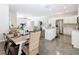 Open-concept kitchen with stainless steel appliances, white cabinetry, and island seating at 481 Kensington View Dr, Winter Haven, FL 33880