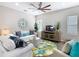 Inviting living room featuring a modern ceiling fan, comfortable seating, natural light, and cozy decor elements at 481 Kensington View Dr, Winter Haven, FL 33880