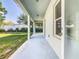 A view of the covered back patio with a concrete floor and a doorway into the home at 481 Kensington View Dr, Winter Haven, FL 33880