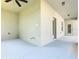 An empty covered back patio, featuring neutral walls, a concrete floor and ceiling fan at 481 Kensington View Dr, Winter Haven, FL 33880