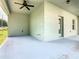 An empty covered back patio, featuring neutral walls, a concrete floor and ceiling fan at 481 Kensington View Dr, Winter Haven, FL 33880