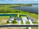 An aerial shot of a beautiful single-story home in a neighborhood with lake views, showcasing its location at 505 Adams View Ln, Auburndale, FL 33823