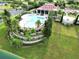 Aerial view of the community pool surrounded by lush landscaping at 505 Adams View Ln, Auburndale, FL 33823
