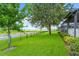 Expansive backyard featuring lush lawn, rod iron fence and mature trees at 505 Adams View Ln, Auburndale, FL 33823