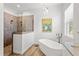 Walk-in shower and standalone tub with modern fixtures in a well-lit bathroom at 505 Adams View Ln, Auburndale, FL 33823