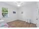 Bright bedroom featuring wood flooring, a ceiling fan, and a large window at 505 Adams View Ln, Auburndale, FL 33823