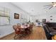 Dining area with wood floors, large windows, and view of kitchen and living area at 505 Adams View Ln, Auburndale, FL 33823