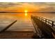 Dock and boat ramp with lake view at sunset at 505 Adams View Ln, Auburndale, FL 33823