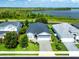 A charming single-story home with a manicured lawn and a view of the lake in the background at 505 Adams View Ln, Auburndale, FL 33823