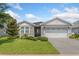 Charming single-story home boasts beautiful landscaping, pavers and a two-car garage at 505 Adams View Ln, Auburndale, FL 33823