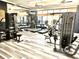 Community gym with various exercise machines, weights, and mirrors at 505 Adams View Ln, Auburndale, FL 33823