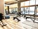 Bright community gym with exercise bikes, weight machines, dumbbells, benches, mirrors and light wood-look floors at 505 Adams View Ln, Auburndale, FL 33823