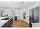 Modern kitchen with white cabinets, stainless steel appliances, hardwood floor, and large island at 505 Adams View Ln, Auburndale, FL 33823