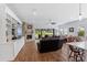 Spacious living room with brick fireplace, wood floors, built-in shelving, and sliding glass doors to patio at 505 Adams View Ln, Auburndale, FL 33823