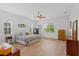Bright bedroom with wood-look tile floors, ceiling fan, and multiple windows for natural light at 505 Adams View Ln, Auburndale, FL 33823