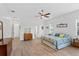 Bright bedroom with wood-look tile floors, ceiling fan, and multiple windows for natural light at 505 Adams View Ln, Auburndale, FL 33823