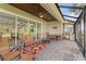 Screened patio with brick floor, wicker seating, ceiling fan, dining table and grill at 505 Adams View Ln, Auburndale, FL 33823