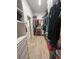 Spacious walk-in closet with shelving, hanging racks, and wood-look tile flooring at 505 Adams View Ln, Auburndale, FL 33823