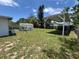 Wide shot of the backyard featuring a carport, shed, and grassy area at 507 Avenue H Se, Winter Haven, FL 33880