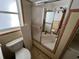 Bathroom featuring a shower with sliding doors, window, and toilet at 507 Avenue H Se, Winter Haven, FL 33880