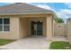 The back patio shows the back door entrance to the home with stone flooring at 536 Squires Grove Dr, Winter Haven, FL 33880