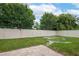 Fenced backyard with stone tile area, offering privacy and outdoor space at 536 Squires Grove Dr, Winter Haven, FL 33880