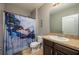 Bathroom featuring blue marble shower curtain, neutral walls, sink and mirror at 536 Squires Grove Dr, Winter Haven, FL 33880